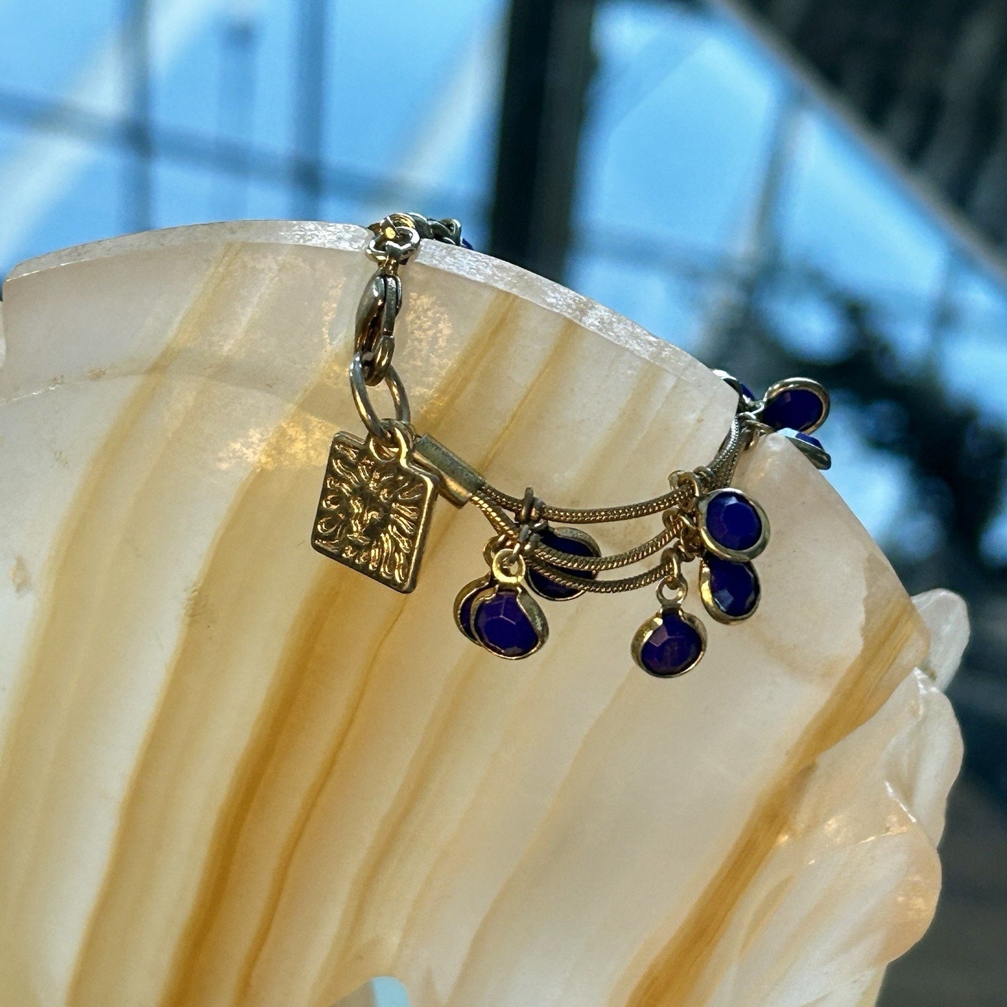 Gold Tone Multi-Strand Charm Bracelet with Blue Round Dangle Accents