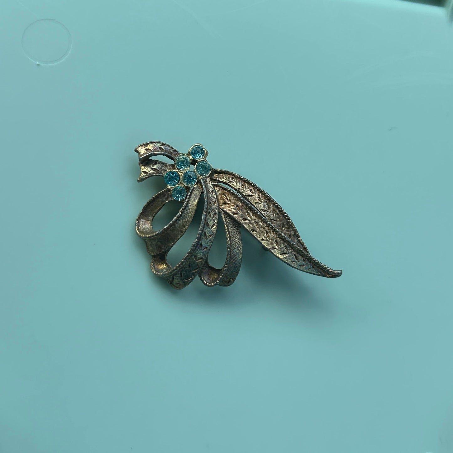 Vintage Gold-Tone Textured Ribbon Bow Brooch with Light Blue Rhinestone Accents