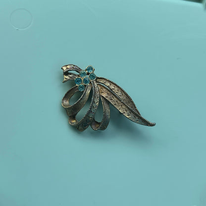 Vintage Gold-Tone Textured Ribbon Bow Brooch with Light Blue Rhinestone Accents